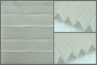 Tkanina plisowana Prato 10751 o delikatnej strukturze i przepuszczająca światło w kolorze piaskowej bieli.	